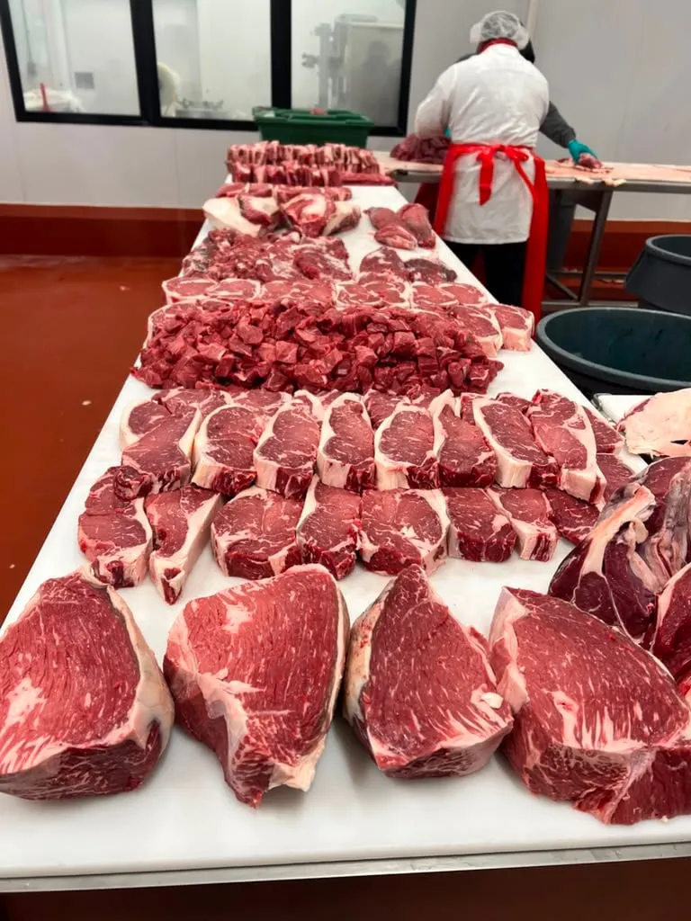 A butcher working the cutting table