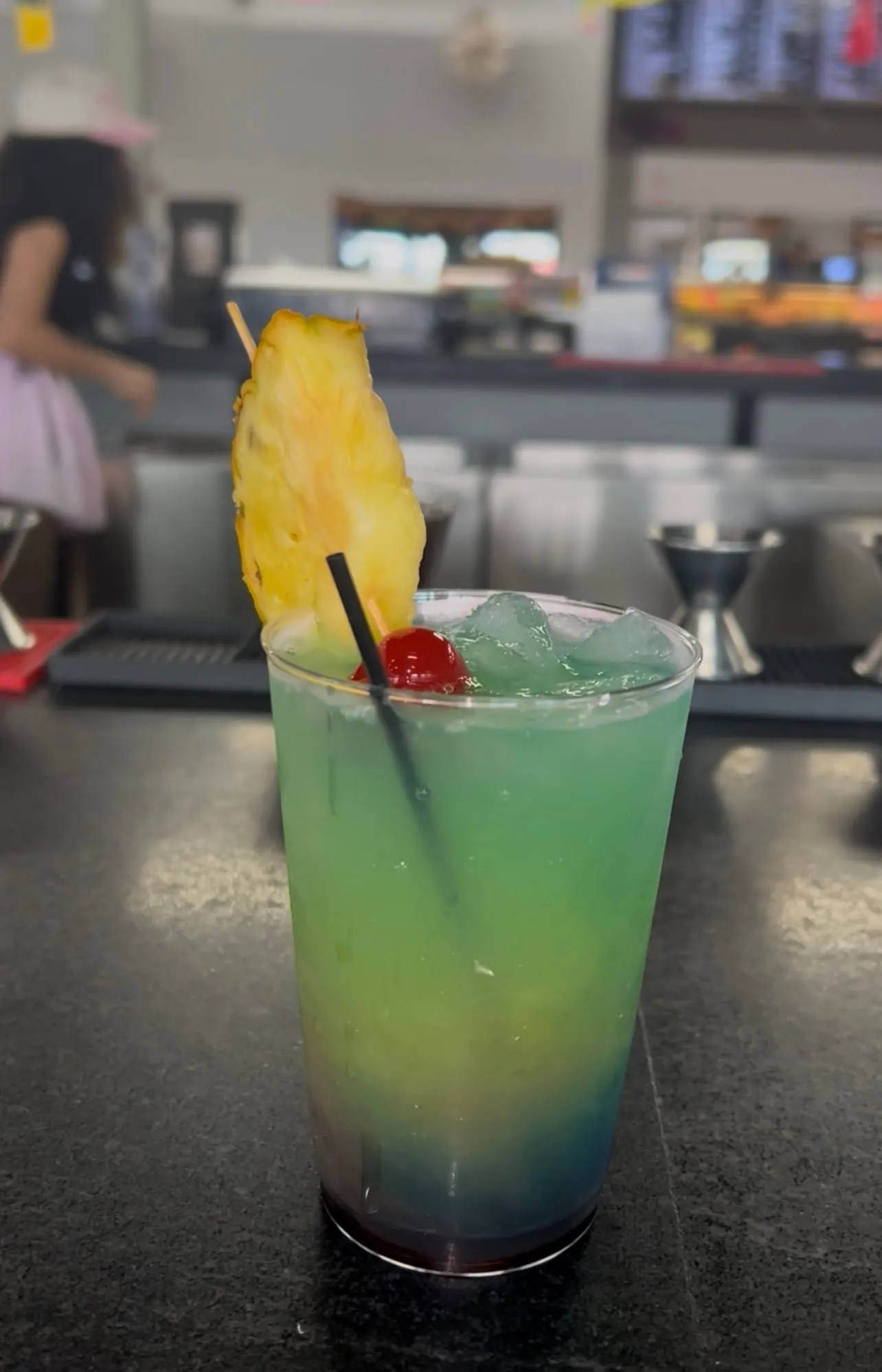 A layered tropical cocktail with pineapple