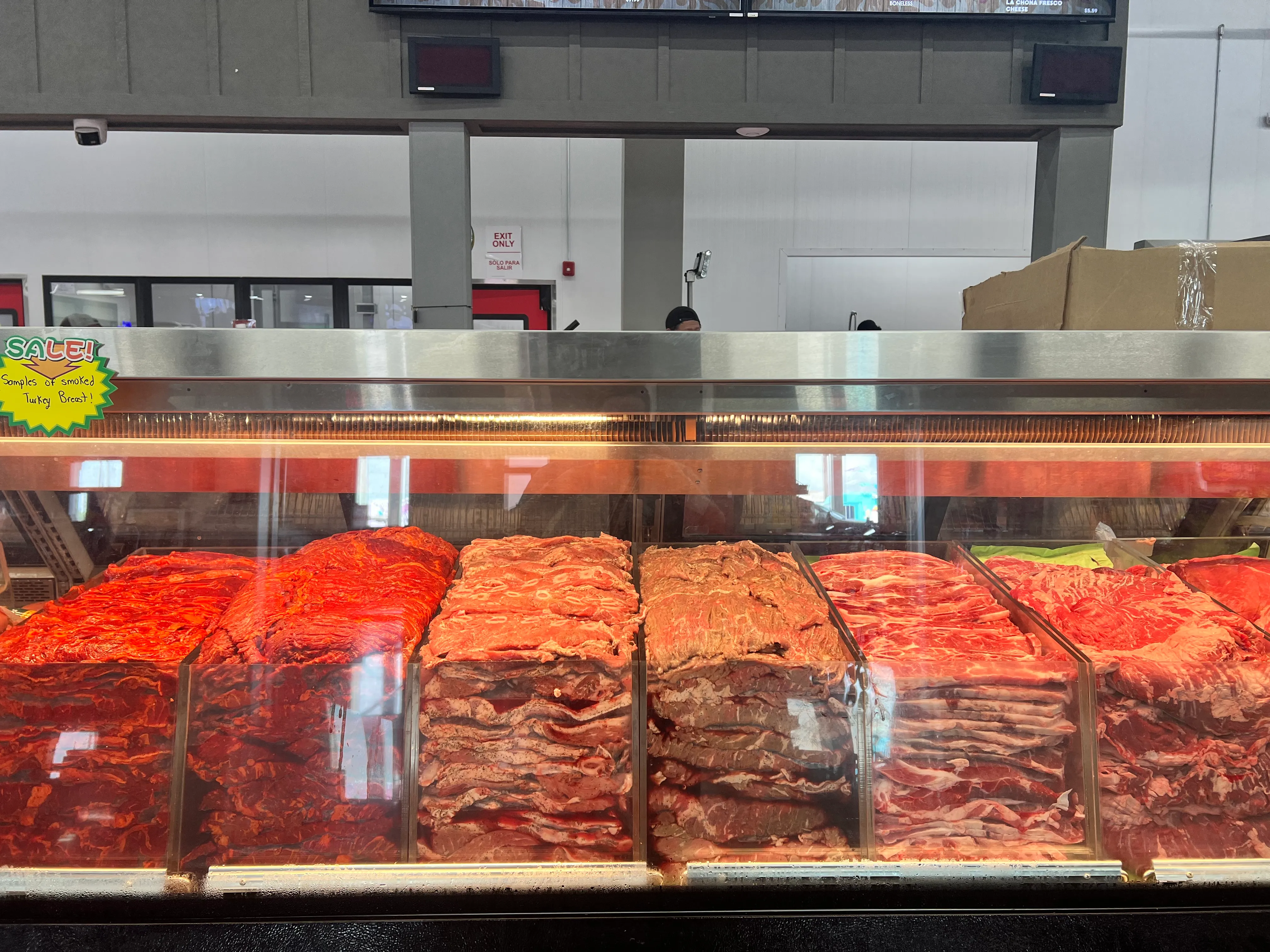 The meat case filled with marinated cuts, fajita and steaks