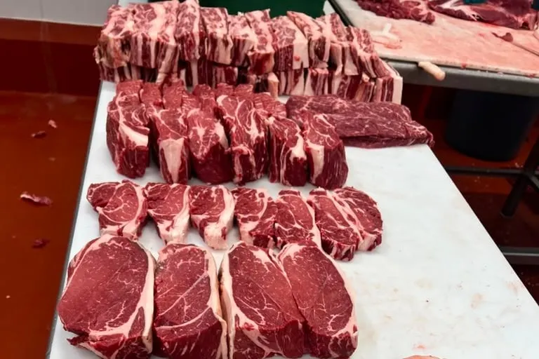 Steaks freshly cut and laid out on the cutting table